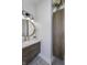 Stylish bathroom with a modern vanity, round mirror, and a wood-look storage cabinet at 8695 Morgan Dr, Fishers, IN 46038