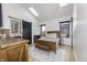 Bright bedroom with vaulted ceilings, skylights, a wooden bed frame, and a sliding barn door to the ensuite bathroom at 8695 Morgan Dr, Fishers, IN 46038