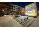 Night view of a charming courtyard with string lights, mural, and modern outdoor seating area at 8695 Morgan Dr, Fishers, IN 46038