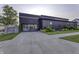 Beautifully landscaped modern home with a spacious driveway, lush green lawn, and convenient access to the garage at 8695 Morgan Dr, Fishers, IN 46038