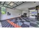 Large garage with patterned flooring, ample room for storage, and a partially open glass door at 8695 Morgan Dr, Fishers, IN 46038