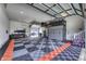 Spacious garage with checkered flooring, ample storage, and a motorcycle at 8695 Morgan Dr, Fishers, IN 46038