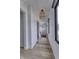 Hallway with hardwood floors, modern lighting, and a view of the outdoors through a black-framed window at 8695 Morgan Dr, Fishers, IN 46038