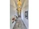 Long hallway featuring shoe storage, pendant lighting, and a mirror at the end of the hall at 8695 Morgan Dr, Fishers, IN 46038