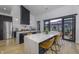 Stylish kitchen with a large island, barstool seating, stainless steel appliances, and sliding door access to the patio at 8695 Morgan Dr, Fishers, IN 46038