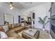 Spacious living room featuring a leather sectional sofa and an open concept view of the modern kitchen at 8695 Morgan Dr, Fishers, IN 46038