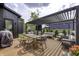 Outdoor deck with pergola featuring comfortable seating, dining table, and grill at 8695 Morgan Dr, Fishers, IN 46038
