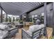Outdoor deck with pergola featuring comfortable seating, dining table, and grill at 8695 Morgan Dr, Fishers, IN 46038