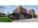 Restaurant exterior with outdoor patio seating, red brick facade, and eye-catching signage at 8695 Morgan Dr, Fishers, IN 46038