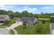 Aerial view of single Gathering home with manicured lawn, tree, and attached two car garage at 930 Penstock Ct, Avon, IN 46123