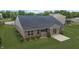 View of the home's backyard with a patio, well-kept lawn, and brick exterior, providing a relaxing outdoor space at 930 Penstock Ct, Avon, IN 46123