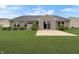 Well-maintained backyard with lush green grass, patio, and manicured shrubs at 930 Penstock Ct, Avon, IN 46123