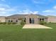 Well-maintained backyard with lush green grass, patio, and manicured shrubs at 930 Penstock Ct, Avon, IN 46123