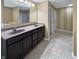 Bathroom featuring double sink vanity with granite countertop and large mirror at 930 Penstock Ct, Avon, IN 46123