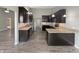 A full kitchen with stainless appliances, dark cabinets, granite counters, and hardwood floors at 930 Penstock Ct, Avon, IN 46123