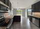 Modern kitchen with stainless steel appliances, granite countertops, and dark wood cabinets at 930 Penstock Ct, Avon, IN 46123