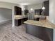 Kitchen with dark cabinetry, light granite countertops, modern stainless steel appliances and hardwood floors at 930 Penstock Ct, Avon, IN 46123