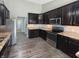 Kitchen features stainless steel appliances, granite countertops, and dark wood cabinets at 930 Penstock Ct, Avon, IN 46123