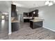 Spacious kitchen with sleek countertops, dark wood cabinetry, stainless steel appliances, and hardwood floors at 930 Penstock Ct, Avon, IN 46123