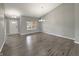 Open-concept living area with hardwood floors and plenty of natural light and a white front door at 930 Penstock Ct, Avon, IN 46123