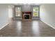 Comfortable living room featuring hardwood flooring, fireplace, and neutral wall paint at 930 Penstock Ct, Avon, IN 46123