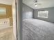Spacious primary bedroom with a ceiling fan, large window, and attached bathroom at 930 Penstock Ct, Avon, IN 46123