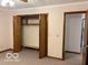 Bedroom with carpet and an open closet and a door leading to another room at 9451 S Amanda Dr, Claypool, IN 46510