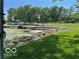 Lakeside property view with a private dock and boats, framed by a rock shoreline and green grass at 9451 S Amanda Dr, Claypool, IN 46510