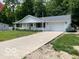 Well-maintained home with a spacious driveway and lush landscaping around the property at 9451 S Amanda Dr, Claypool, IN 46510