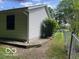 Side view of the home's exterior, showcasing landscaping and yard at 9451 S Amanda Dr, Claypool, IN 46510