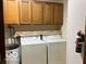 Functional laundry area with washer, dryer, and overhead cabinets for storage at 9451 S Amanda Dr, Claypool, IN 46510