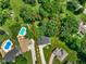 Aerial view showcasing the property with mature trees, pool and outdoor living space at 955 Wood Creek Pl, Greenwood, IN 46142