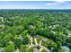 Aerial view of a home nestled among mature trees and well-manicured lawns at 955 Wood Creek Pl, Greenwood, IN 46142