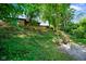 Backyard view with fire pit, mature trees, and lush lawn at 955 Wood Creek Pl, Greenwood, IN 46142