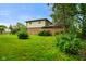 Backyard view of two-story home with large lawn and mature trees at 955 Wood Creek Pl, Greenwood, IN 46142
