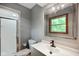 Modern bathroom featuring a vanity with a large mirror and a tiled shower with glass doors at 955 Wood Creek Pl, Greenwood, IN 46142
