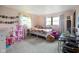Cozy bedroom with two windows, desk, a bed, dollhouse and storage at 955 Wood Creek Pl, Greenwood, IN 46142