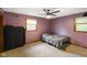 Cozy bedroom with a ceiling fan, carpeted floor, and natural light from two windows at 955 Wood Creek Pl, Greenwood, IN 46142