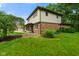 Side view of charming home featuring brick facade, green lawn, and a covered porch area at 955 Wood Creek Pl, Greenwood, IN 46142