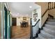 Inviting foyer with hardwood floors, staircase, and open view into the dining area at 955 Wood Creek Pl, Greenwood, IN 46142