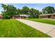 Charming two-story home featuring an attached garage, a lush green lawn, and mature trees at 955 Wood Creek Pl, Greenwood, IN 46142