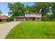 Charming two-story home featuring a brick facade, attached garage, and expansive green lawn at 955 Wood Creek Pl, Greenwood, IN 46142