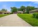 Charming home with a long driveway, green lawn, mature trees, and an American flag waving in the breeze at 955 Wood Creek Pl, Greenwood, IN 46142