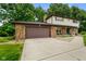 Charming home featuring a brick facade, an attached garage, and a well-manicured green lawn at 955 Wood Creek Pl, Greenwood, IN 46142