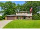 Charming two-story home featuring a well-manicured lawn, brick accents, and an attached two-car garage at 955 Wood Creek Pl, Greenwood, IN 46142