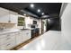 Modern kitchen featuring white cabinets, countertops and black appliances at 955 Wood Creek Pl, Greenwood, IN 46142