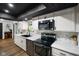 Bright kitchen with white cabinets, stainless steel appliances and brick backsplash at 955 Wood Creek Pl, Greenwood, IN 46142