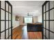 Inviting living room showcased through french doors, highlighting the hardwood floors and natural light at 955 Wood Creek Pl, Greenwood, IN 46142
