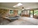 Relaxing sunroom with brick walls, skylight, ceiling fan, and hammock at 955 Wood Creek Pl, Greenwood, IN 46142