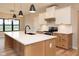 Modern kitchen with a large island, white countertops, and stainless steel appliances under hanging lights at O Legacy Estates-Lot 5, Mooresville, IN 46158